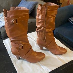 Knee-high boots. Never worn, sticker is still on sole